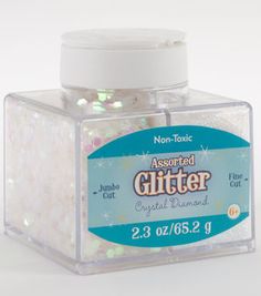 a clear container filled with glitter on top of a white table