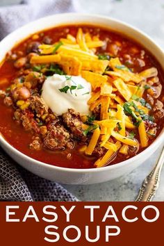 easy taco soup in a white bowl with sour cream on top and the title above it