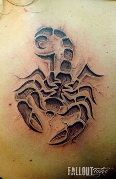 a tattoo on the back of a woman's shoulder with a scorpion in it