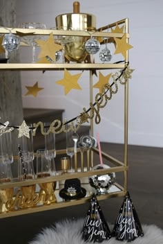 a gold bar cart filled with glasses and confetti