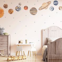 a child's bedroom with planets and stars on the wall