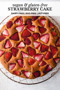 a close up of a cake on a rack with strawberries and gluen - free