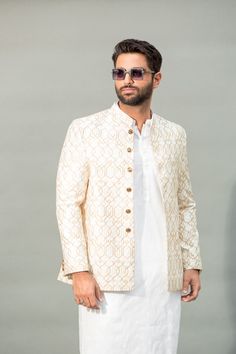 Welcome to Shiraz Saeed Our Retail Store: Rubina's Collection 2070 W Spring creek Pkwy Suite 328 Plano,TX USA 75023 Presenting Men's Off-White Embroidered Jamawar Prince Coat (Kindly provide your size upon checkout) Color: Off-White Premium Embroidered Jamawar Banarsi Fabric Italian Thread Simple & Decent Metal Buttons Finest Stitch Branded Design Custom Sizes are also available. Fit Type: Regular fit Wash Care Instructions: Dry Clean Only Suitable For India Wedding, Festivals And Social Gatherings Disclaimer Due to the photographic lighting & different screen calibrations, the colors of the original product may slightly vary from the picture. Fitted Classic Traditional Wear For Wedding, Classic Gold Long Sleeve Sets, White Classic Sherwani For Formal Occasions, Classic White Bandhgala For Festive Occasions, Classic White Traditional Wear For Festive Season, Classic Cream Nehru Jacket For Wedding, White Nehru Jacket With Intricate Embroidery For Reception, White Nehru Jacket With Resham Embroidery For Wedding, Classic White Sherwani For Festive Occasions