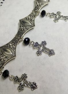 Victorian Gothic metal choker with hollow crosses and black crystal beads, ornate metal necklace, Victorian jewelry, Gothic jewelry A beautifully ornate gothic silver metal choker with Victorian hollow cross charms and black faceted crystal beads. It measures approx. 11 inches in length and has lobster clasp fastening and an extension chain, so that it can be adjusted to fit the neck. The choker is made up of 7 silver toned metal ancient style sections that have intricate detailing. A marvelous Gothic Silver Metal Body Jewelry, Silver Gothic Metal Body Jewelry, Silver Gothic Body Jewelry, Gothic Choker Necklace For Jewelry Making, Gothic Nickel-free Choker Jewelry, Gothic Nickel-free Choker, Nickel-free Gothic Choker Jewelry, Adjustable Gothic Metal Necklace, Gothic Ankh Necklace In Metal