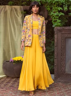 Editor's Note This set features a yellow blazer with a crop top and palazzo. Color: Yellow Fabric: Crepe; Organza Care: Dry Clean Only About the Designer Chhavvi Aggarwal design philosophy is about amalgamating Indian embroideries with modern silhouettes, resulting in exquisite ensembles perfect for various occasions. The details, colors, and cuts are carefully thought out resulting in flattering silhouettes, which would make every woman stand out and feel beautiful. Crop Top Outfits Indian, Crop Top Palazzo, Organza Suit, Organza Suits, Western Dresses For Women, Printed Organza, Trendy Outfits Indian, Blazer Outfits For Women