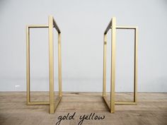 two golden frames sitting on top of a wooden floor next to each other with the words gold yellow in front of them