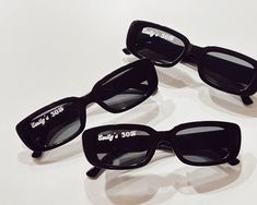 three pairs of black sunglasses with the words daddy's sons on them sitting on a white surface