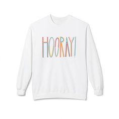 Celebrate in style with this colorful and fun hand-drawn graphic sweatshirt. The funky letters and hooray message give a festive vibe that is perfect for any celebration. This unisex sweatshirt is easy to wear and offers a relaxed fit with dropped shoulders, ribbed cuffs, and bottom hem. Made from a medium-heavy fabric, it is comfortable and stylish for all occasions. Product features - Dropped shoulders for a relaxed fit - 1x1 Ribbed cuffs and bottom hem with spandex for stretch - Without side seams for a more attractive design - 80% Ringspun cotton, 20% Polyester for softness and durability - Medium-heavy fabric for comfort Care instructions - Machine wash: cold (max 30C or 90F) - Non-chlorine: bleach as needed - Tumble dry: low heat - Iron, steam or dry: low heat - Do not dryclean Funky Letters, Cozy Winter, Heavy Fabric, Gift For Him, Unisex Sweatshirt, San Jose, Sweat Shirt, Gifts For Him, Favorite Outfit