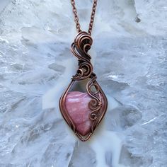 This dainty rhodonite heart has been hand wrapped in antique copper wire with a swirling motif and comes with an 18" clasped copper chain, gift packaging and free tracked shipping in North America.  Rhodonite Heart and Antique Copper Wire Wrapped Pendant Necklace Copper Wire Teardrop Pendant Jewelry Gift, Copper Wire Teardrop Pendant Jewelry For Gift, Rose Gold Copper Wire Necklace For Gift, Rose Gold Copper Wire Necklace Gift, Pink Wire Wrapped Copper Jewelry, Elegant Rhodonite Jewelry Gift, Elegant Rhodonite Jewelry For Gifts, Pink Wire Wrapped Copper Wire Jewelry, Wire Pendant Necklace As A Gift