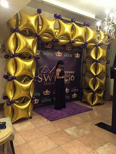 a woman standing in front of a stage set up for a masquerade show