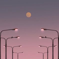 an image of some street lights in the sky at night with a full moon behind them