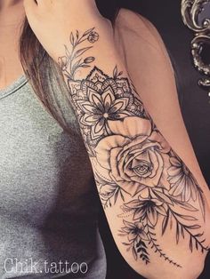 a woman with a flower tattoo on her arm