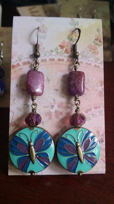 These Butterfly earrings feature lepidolite gemstones, purple crystals, and antiqued brass. Made in the U.S.A.  I craft original, to order, and customizations on weekends, and ship Tuesday.  Orders placed for in stock, as-is items ship within 3 business days or faster.  If you need a piece in a hurry, please shoot me a note and let me know so that I can do my best to accommodate you! Consignment pieces can be undertaken, including full design and manufacture of custom brooches, rings, pendants/n Purple Czech Glass Earrings For Gift, Nickel-free Purple Czech Glass Jewelry, Hypoallergenic Purple Bohemian Earrings, Purple Czech Glass Dangle Jewelry, Purple Czech Glass Jewelry With Matching Earrings, Nickel-free Purple Enamel Jewelry, Purple Vintage Jewelry, Mismatched Jewelry, Purple Crystals