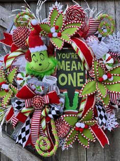 a christmas wreath with a green grin the cat in the hat on top of it