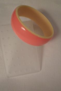 "This funtastic piece is striped, layered and laminated in bright orange and lemon yellow. Measuring 15/16\" wide, the inside diameter is 2-5/8\" and the bangle is in excellent vintage condition!" Pink Plastic Bangle Bracelet, Pink Plastic Bangle Jewelry, Neon Jewelry, Hip Jewelry, Black Bangle, Orange Jewelry, Lucite Jewelry, Plastic Bangles, Retro Accessories