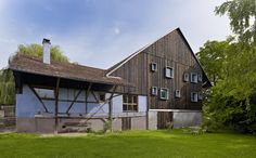 an old wooden house with blue paint and windows