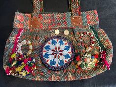 a handbag that is decorated with beads and other things on the inside of it