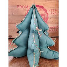 a blue cloth christmas tree sitting on top of a wooden table