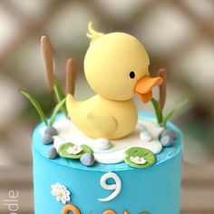 a birthday cake with a rubber ducky on it's top and the number nine