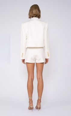 The Alana Cropped Blazer is a must-have outwear piece for every occasion. This seasonless blazer will always add a touch of chicness to your look through its gold detailing and cropped fit. Luxury Cropped Blazer For Spring, Chic White Cropped Blazer, Nylon Dress, Cropped Blazer, Silver Shoes, White Blazer, Engineered Garments, Sweater Sleeves, Blazers For Women