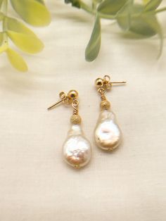 These are beautiful pearl earrings with 14K gold fill.  The bead is gold dust with lots of sparkle.  Great for everyday wear or for that special occasion. Pearl Earrings With Gold Beads For Gift, Pearl Drop Earrings With Gold Beads, Gold Beaded Pearl Earrings, Gold 14k Gold-filled Pearl Earrings For Anniversary, Gold Pearl Earrings With Gold Beads, Gold 14k Gold Filled Pearl Earrings For Anniversary, Everyday Pear-shaped Gold Earrings, Elegant Gold Pearl Earrings With Gold Beads, Gold Pear-shaped Pearl Charm Earrings