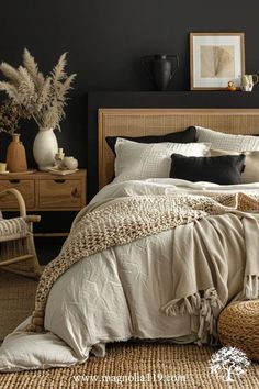 a bedroom with black walls, wicker furniture and white linens on the bed