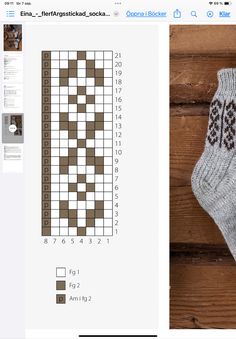 a pair of socks sitting on top of a wooden floor next to a crossword puzzle