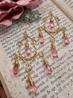 "One word: SENSATIONAL!  These chandelier earrings are stunning in every way possible! Super elegant with tons of sparkle!  Earring deets:  Using a sturdy gold bead wire I created this gorgeous pair of chandelier style earrings! I adorned these chandelier beauties with pink faceted glass briolettes with the most remarkable sparkle. These earrings are whimsical and absolutely beautiful!  Each pair is made to order. Some slight size variations may occur with stones or frame work. These are handmad Cheap Pink Metal Chandelier Earrings, Cheap Pink Bohemian Chandelier Earrings, Frame Work, Beaded Chandelier Earrings, Bead Wire, Holiday Earrings, Earrings Teardrop, Be Gentle With Yourself, Beaded Chandelier