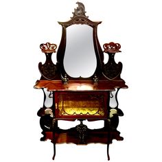 an ornate wooden vanity with mirror on it's side and lights in the middle