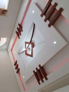 the ceiling is decorated with modern art and wood pieces in shades of brown, white and red