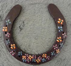 a chocolate horseshoe with sprinkles and colored beads on the inside of it