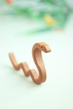 a wooden toy snake sitting on top of a table