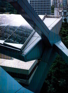 an aerial view of buildings and trees in the foreground with skyscrapers in the background