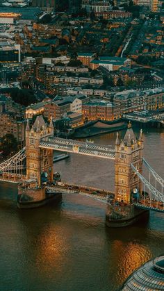 an aerial view of the tower bridge in london, england at night with lights on