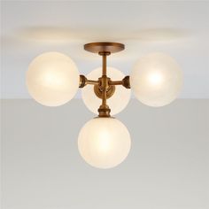 three globes are hanging from the ceiling in this modern style chandelier fixture