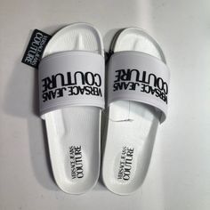 Authentic Versace Jeans Couture Slide Logo Open-Toe White Slides Sandals. New With Tags Size: 8 Us/38 Eu -Raised Logo At Toe Strap -Contoured Footbed For Optimal Comfort -Slip On -Rubber Upper, Lining, And Sole Check The Authenticity Of These Sandals On Versace.Com Or At Any Versace Store (The Picture With The Code Included) Designer Open Toe Slides For Beach, Designer Slides For Spring Beach Outing, Designer Slides For Beach And Spring, Designer Slides With Branded Insole For Beach, Designer Beach Slides With Branded Insole, Designer Synthetic Slides For Summer, Luxury White Synthetic Sandals, Designer Round Toe Summer Slides, Designer Round Toe Slides For Summer