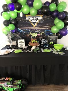 a monster jam themed birthday party with balloons and desserts on a black tablecloth