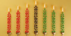 a row of candles with different colored beads on them