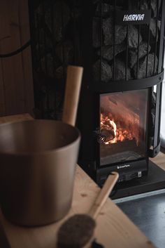 a wood burning stove next to a bowl and spoon