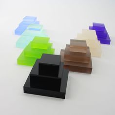 several different colors of glass blocks on a white surface