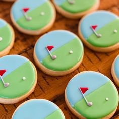 decorated cookies are arranged in the shape of golf holes