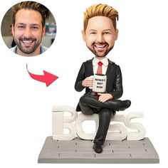 a bobble head sitting on top of a sign with the word boss next to it