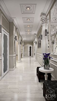 a long hallway with white walls and marble floors