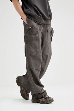 The Multi-Pocket Crinkled Drawstring Cargo Pants blend street style with a rugged, post-apocalyptic vibe. Featuring a dirty-fit, these pants have large pockets sewn onto both thighs for functionality and style. The crinkled design at the knees adds texture, while the adjustable waistband with a strap and drawstring ensures a customizable fit. Drawstrings at the cuffs allow for further adjustments, making these slightly oversized cargo pants both practical and bold. Crafted from premium 100% cott Casual Baggy Distressed Cargo Pants, Baggy Grunge Bottoms With Multiple Pockets, Grunge Washed Pants For Streetwear, Baggy Distressed Washed Black Pants, Baggy Grunge Washed Pants, Washed Black Grunge Bottoms With Pockets, Baggy Grunge Pants With Pockets, Grunge Bottoms With Cargo Pockets, Urban Washed Black Pants With Side Pockets