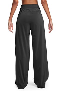 Crisp pleats play up the wide-leg silhouette of these comfortable, casual pants embellished with a signature Swoosh logo. 31" inseam; 24 1/2" leg opening; 14 1/2" front rise; 17 1/2" back rise (size XX-Large) Zip fly with hook-and-bar closure Front slant pockets 81% nylon, 19% spandex Machine wash, tumble dry Imported Nike Bottoms With Elastic Waistband, Nike Relaxed Fit Solid Color Bottoms, Nike Relaxed Fit Full Length Bottoms, Nike Relaxed Fit Solid Pants, Black Full Length Wide Leg Pants With Pull-on Style, Nike Stretch Solid Color Pants, Nike Stretch Pants, Nike Relaxed Wide Leg Bottoms, Nike Wide Leg Loungewear Pants