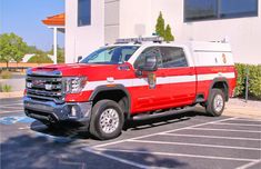 a red and white fire truck parked in a parking lot