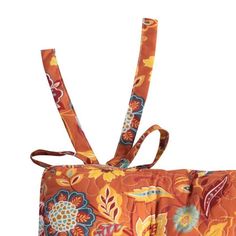 an orange and blue flowered bag with ties on it