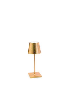 a small gold lamp on a wooden base