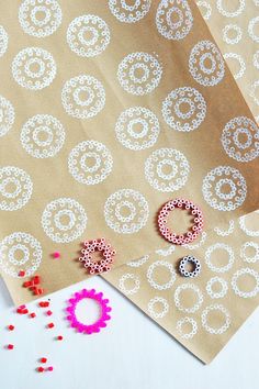 some crafting supplies are laying out on the table next to paper and beading