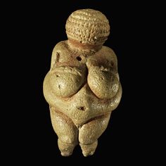 a statue made out of bread on a black background